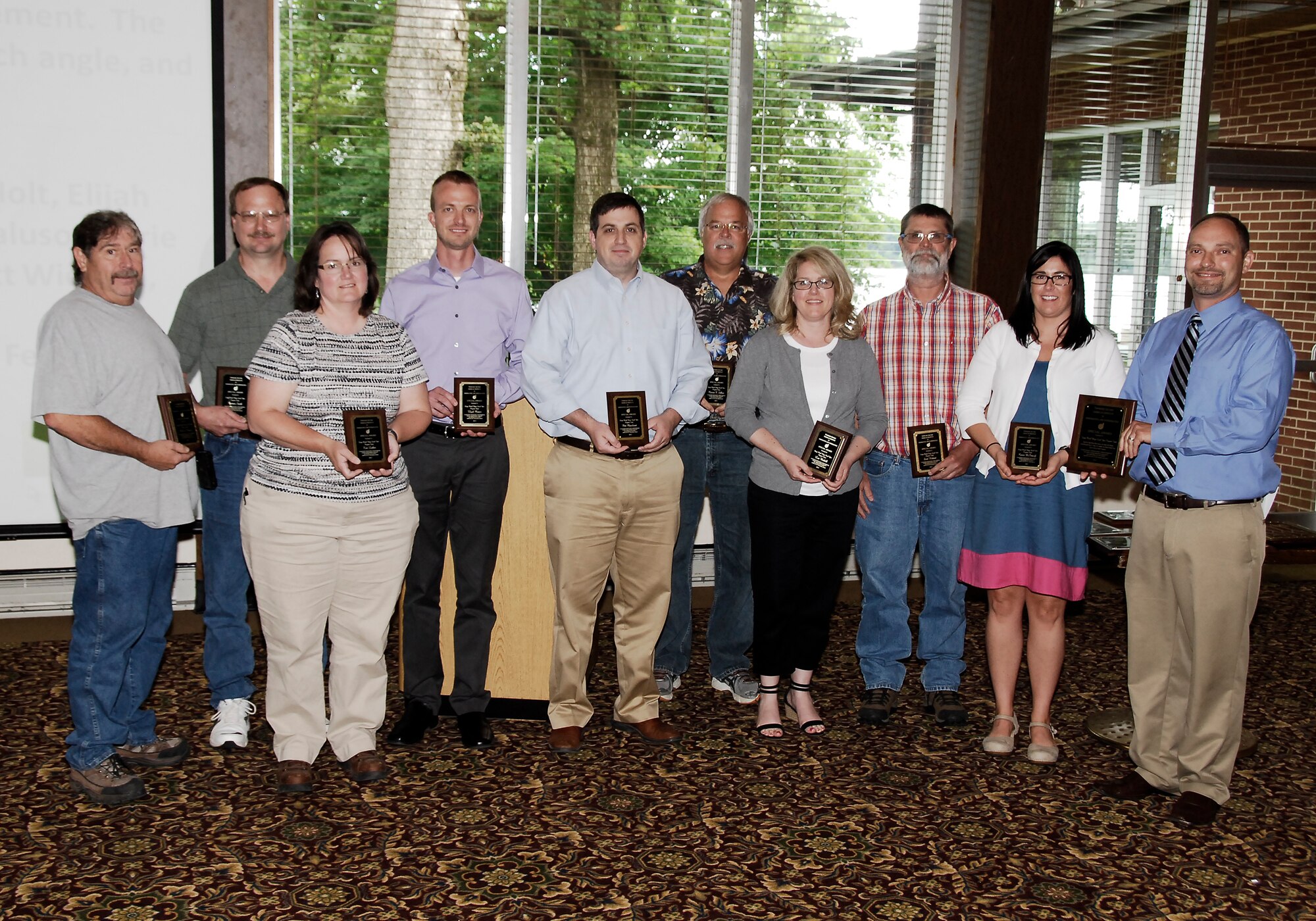 The AEDC Large Model Wings Level Yaw Program Team receives an AIAA Tennessee Section Special Award from nominator Corey Rice (far right) for management and manufacturing innovations resulting in rapid project execution. Team members (left to right): Michael Cowan, Norman Smith, Kim Luther, Elijah Minter, Pete Macaluso, Marvin Sellers, Lisa Waddell, Scott Wieland and Carrie McInturff. Team members not pictured: Keith Holt, Mark Andrews, Mike Mashburn and Schmiede Corp. representatives Kelvin Oldham and Brad Ferrell.