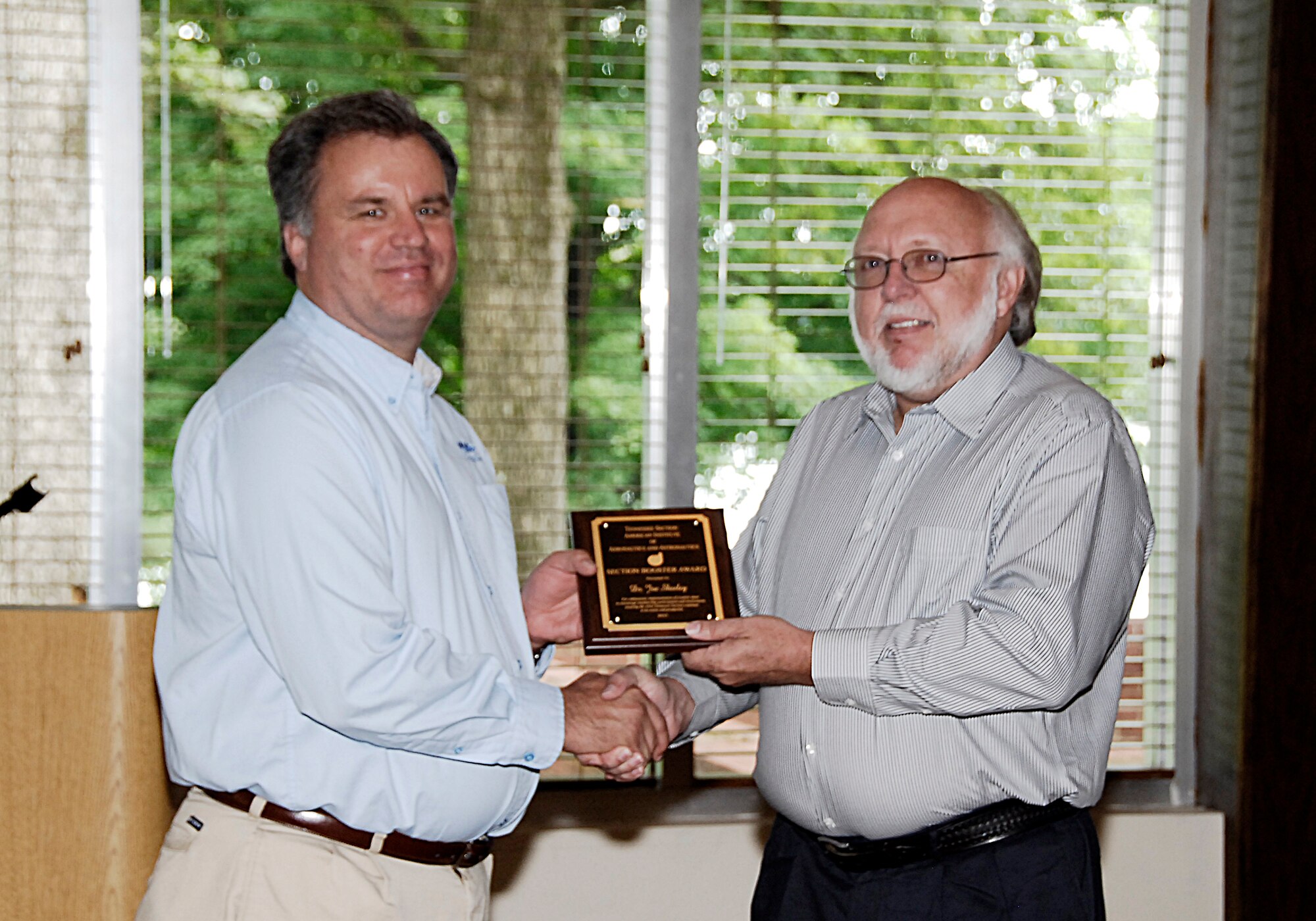 AEDC employee Dr. Joe Sheeley (left) receives an AIAA Tennessee Section Booster Award for his service as Section Chair from nominator and AEDC employee Dr. Robert Howard. (Photos by Rick Goodfriend)