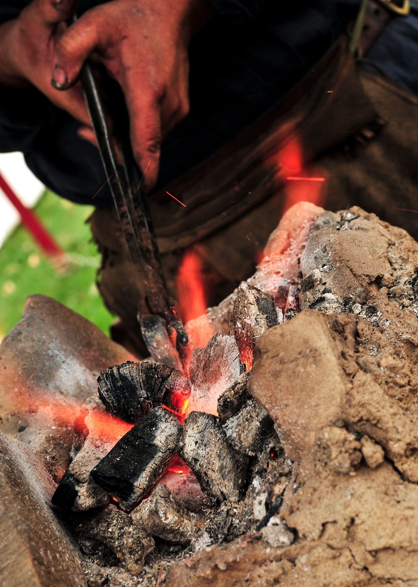 A piece of iron is heated in a homemade forge during Norsk Hostfest Military Appreciation Day in Minot N.D., Oct. 3, 2015. Norsk Hostfest is the largest Scandinavian festival in North America. The event celebrates cultures from Norway, Denmark, Sweden, Finland and Iceland. (U.S. Air Force photo/Senior Airman Stephanie Morris)