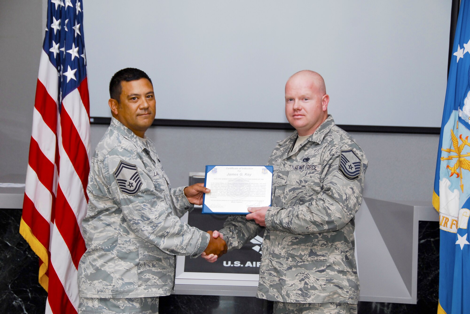 Master Sgt. James Key (right) is pictured accepting his Certificate of Induction from Senior Master Sgt. Patrick Lazarus during his promotion ceremony to master sergeant on May 28. 