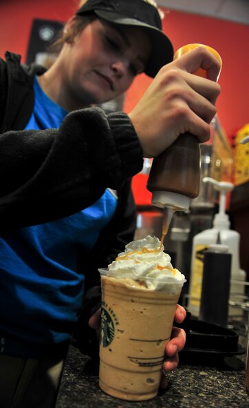 Britany Fithian, barista, makes and serves coffee at the B-Fifty Brew at Minot Air Force Base, N.D., Oct. 7, 2015. The Brew, which falls under the 5th Force Support Squadron, offers a variety of pastries as well as both hot and cold coffee and drinks. The hours of operation for the facility are Monday through Friday 6 a.m. to 6 p.m. and 8 a.m. to 2 p.m. on the weekends. (U.S. Air Force photo/Senior Airman Stephanie Morris)