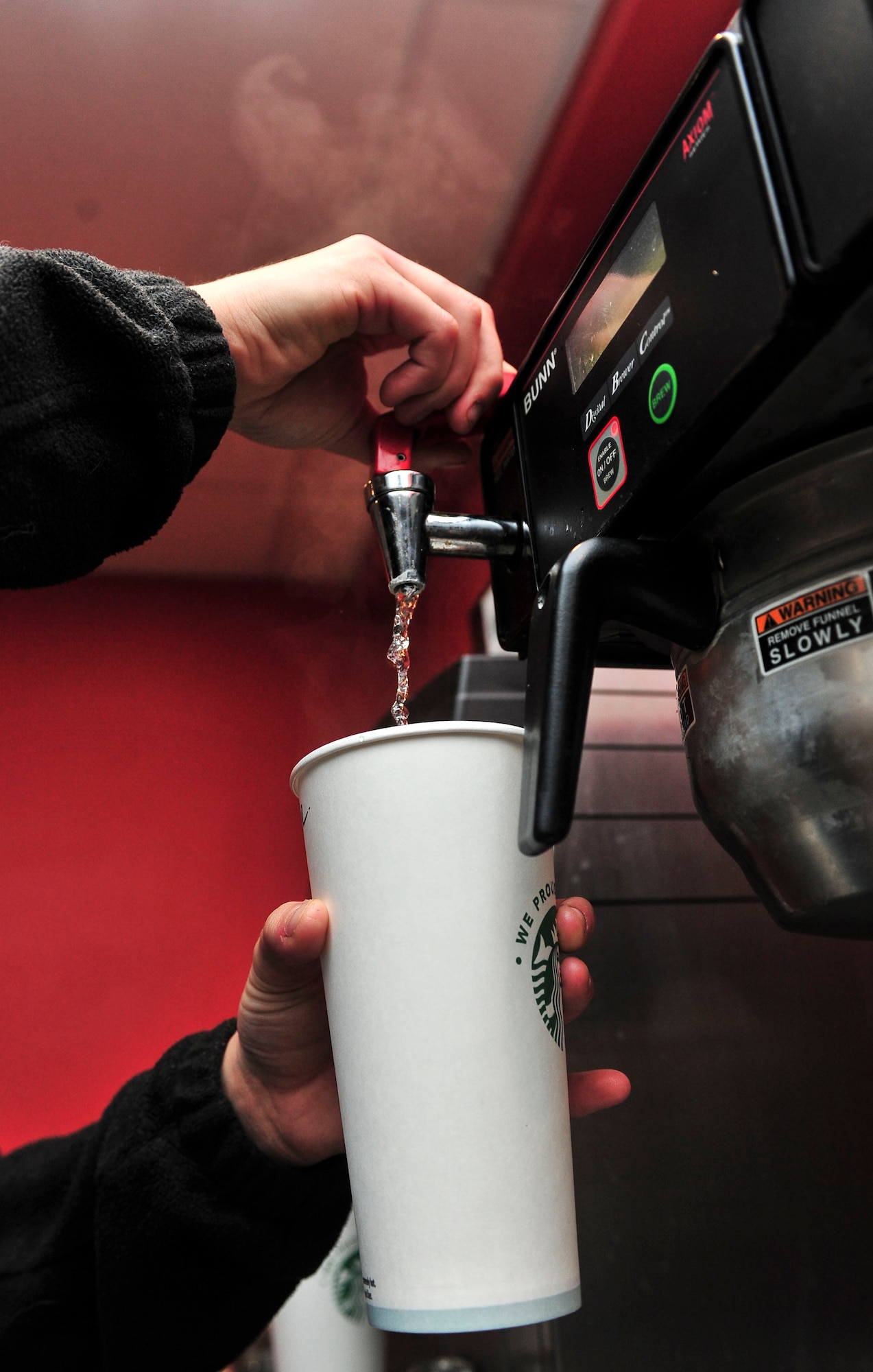 Britany Fithian, barista, makes and serves coffee at the B-Fifty Brew at Minot Air Force Base, N.D., Oct. 7, 2015. The Brew, which falls under the 5th Force Support Squadron, offers a variety of pastries as well as both hot and cold coffee and drinks. The hours of operation for the facility are Monday through Friday 6 a.m. to 6 p.m. and 8 a.m. to 2 p.m. on the weekends. (U.S. Air Force photo/Senior Airman Stephanie Morris)