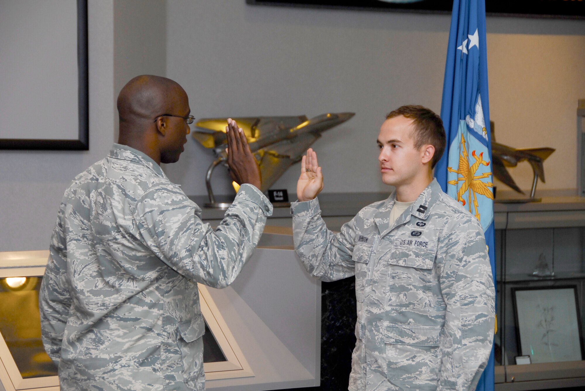 Capt. Chance Johnson (right) takes an oath of office during his promotion ceremony to captain on May 21. Col. Anthony Walker, AEDC Aeropropulsion Ground Test Division director, administers the oath. 

