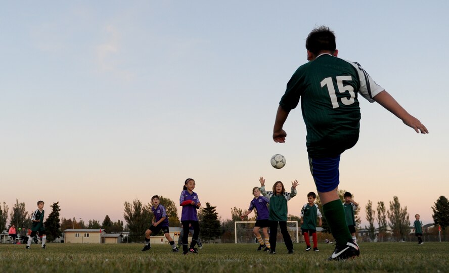 Children from the youth center play soccer at Minot Air Force Base, N.D. Oct. 6, 2015. The children were playing their final soccer game of the season which is part of many programs and activities the youth center provides. (U.S. Air Force photo by Staff Sgt. Chad Trujillo)