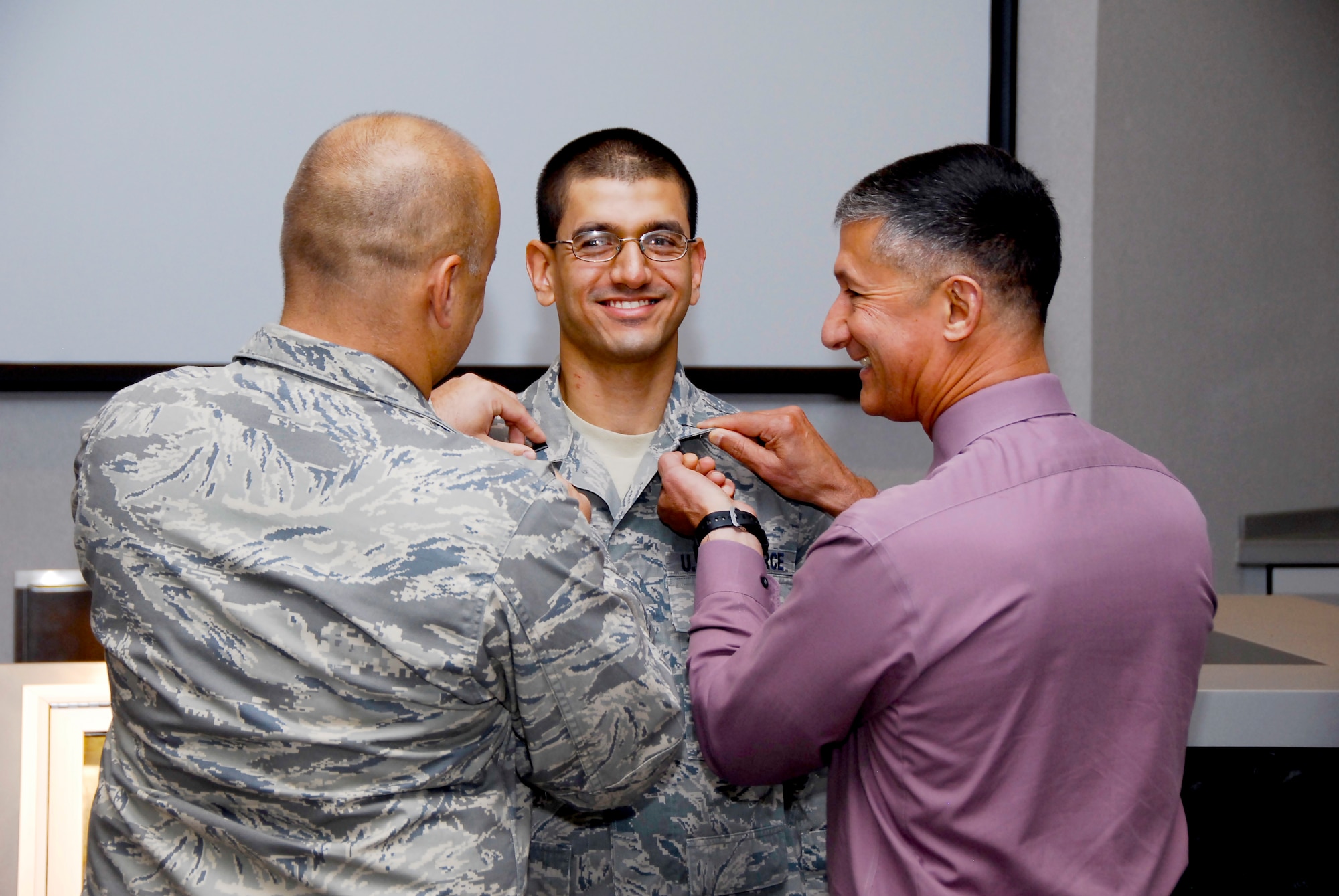 Capt. Akshay Tripathy (center) is pinned to the rank of captain by Lt. Col. Ancie Dotson (left), AEDC Test Operations Division deputy, and Kenneth Jacobsen, AEDC Director of Staff, during his promotion ceremony on May 21.