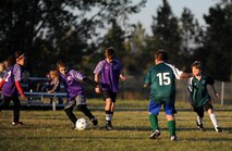 Children from the youth center play soccer at Minot Air Force Base, N.D. Oct. 6, 2015. The children were playing their final soccer game of the season which is part of many programs and activities the youth center provides. (U.S. Air Force photo by Staff Sgt. Chad Trujillo)