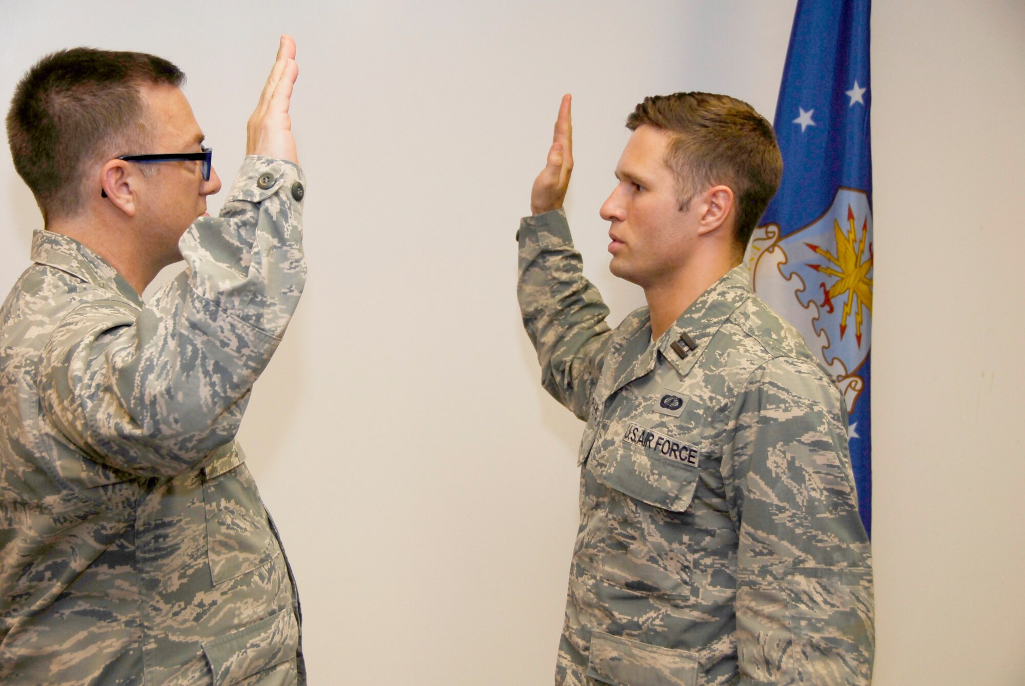 Capt. Sam Stephens (right), takes an oath of office during his promotion ceremony to captain on May 20. Col. Timothy West, AEDC Test Operations Division chief, administers the oath. 