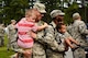 Two Airmen from the 4th Civil Engineer Squadron hold their kids upon their return from deployment, Oct. 13, 2015, at Seymour Johnson Air Force, North Carolina. Airmen across the force continue to support contingencies around the world. (U.S. Air Force photo/Airman Shawna L. Keyes)