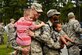 Two Airmen from the 4th Civil Engineer Squadron hold their kids upon their return from deployment, Oct. 13, 2015, at Seymour Johnson Air Force, North Carolina. Airmen across the force continue to support contingencies around the world. (U.S. Air Force photo/Airman Shawna L. Keyes)