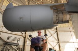 During a Vietnam veteran base tour, Randal Weber sits under one of the C-17 Globemaster III’s engines in a hangar at Joint Base Charleston – Air Base, S.C., Oct. 10, 2015.  Weber served as an Air Force Sgt.  jet engine mechanic. (U.S. Air Force photo/Airman 1st Class Thomas T. Charlton)