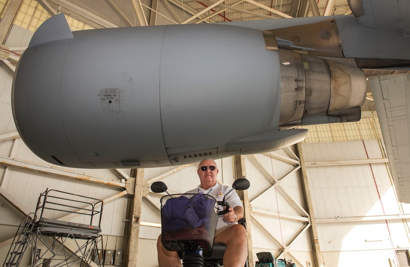 During a Vietnam veteran base tour, Randal Weber sits under one of the C-17 Globemaster III’s engines in a hangar at Joint Base Charleston – Air Base, S.C., Oct. 10, 2015.  Weber served as an Air Force Sgt.  jet engine mechanic. (U.S. Air Force photo/Airman 1st Class Thomas T. Charlton)