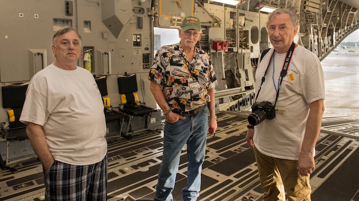 (From left to right) During a Vietnam War veterans base tour, Larry Martino, Joe Burkhart and Doug Severt stand together on a C-17 Globemaster III at Joint Base Charleston – Air Base, S.C., on Oct. 10, 2015. Before retirement Martino was a Sgt. from supply, Burkhart was a Sgt. who worked on aircraft navigations systems avionics and Severt was a MSgt. from aerial port. (U.S. Air Force photo/Airman 1st Class Thomas T. Charlton)