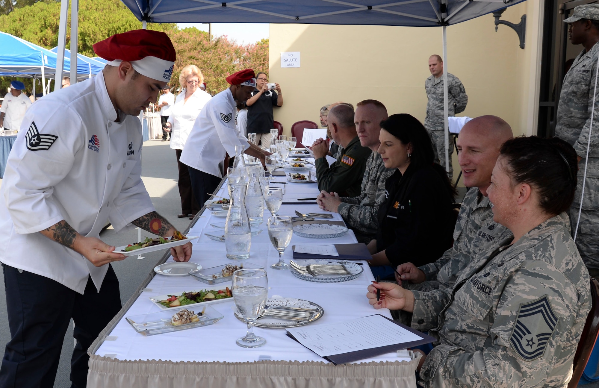 Airmen from the 341st Force Support Squadron Malmstrom Air Force Base, Mont., present their creations to judges during the Global Strike Challenge Chef Competition at Barksdale Air Force Base, La., Oct. 7, 2015. Three Airmen were selected from each base and required to present an entrée and dessert using chicken and green apples. (U.S. Air Force photo/Senior Airman Amanda Morris)