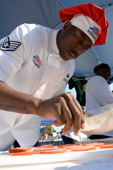 Staff Sgt. Jeremy Reynolds, 5th Force Support Squadron food service specialist from Minot Air Force Base, N.D., dusts spices over tomatoes during the Global Strike Challenge Chef Competition at Barksdale Air Force Base, La., Oct. 7, 2015. Competitors from each base in Air Force Global Strike Command participated in the first chef competition. (U.S. Air Force photo/Senior Airman Amanda Morris) 