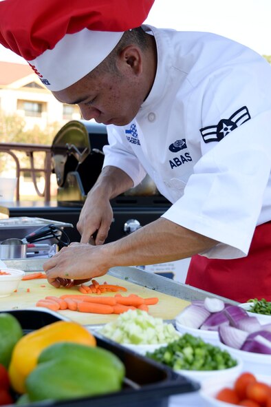 Airman 1st Class Ruel Abastas, 90th Force Support Squadron missile chef from F.E. Warren Air Force Base, Wyo., juliennes carrots during the Global Strike Challenge Chef Competition at Barksdale Air Force Base, La., Oct. 7, 2015. Competitors from each base in Air Force Global Strike Command participated in the first GSC chef competition. Using chicken and green apples as inspiration, each team prepared an entrée and a dessert for 11 judges. (U.S. Air Force photo/Senior Airman Amanda Morris)