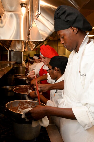 Airmen from various Air Force Global Strike Command bases and culinary students from Bossier Parish Community College melt chocolate while preparing a buffet-style meal to feed 800 people in the local community at BPCC in Bossier City, La., Oct. 6, 2015. The Airmen had the opportunity to collaborate with the culinary students before competing in the Global Strike Challenge Chef Competition, allowing them to learn new tips and tricks and pass along their own. (U.S. Air Force photo/Senior Airman Amanda Morris)
