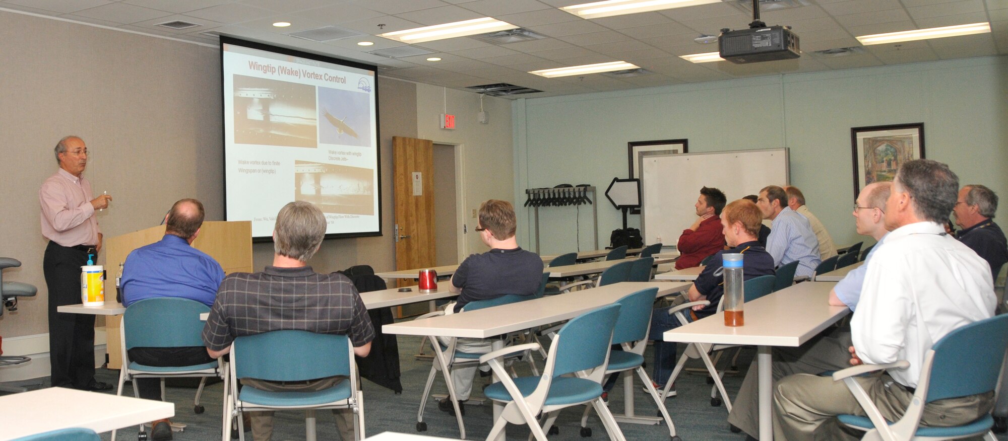ARNOLD AIR FORCE BASE, TENN. – Caption for photo # 150820-F-GV828-005: Dr. Ahmad D. Vakili (far left), Professor of Mechanical and Aerospace Engineering at the University of Tennessee Space Institute, addresses participants at AEDC’s Technical Excellence Seminar Aug.20 on his recent research studies of  ‘Flow Control'. Vakili said flow control has recently become a focus and a component of most research in various aerodynamics and fluid mechanics of advanced systems. (Photo by Jacqueline Cowan)