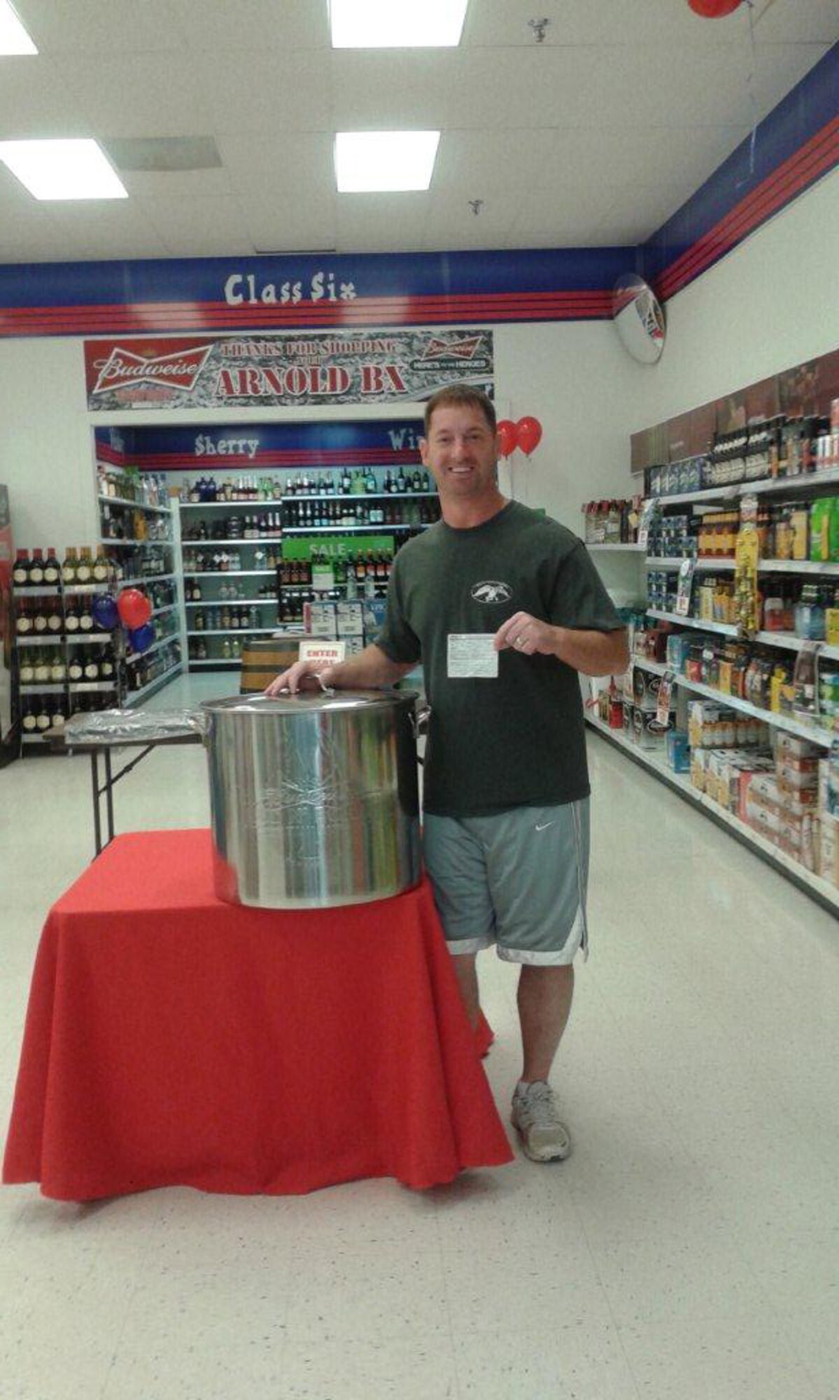 Retired Master Sgt. George Allen displays the crawfish boiler he won at the 120th Anniversary celebration of the Army and Air Force Exchange Service July 25 at the Arnold Air Force Base Exchange. (Photo provided)
