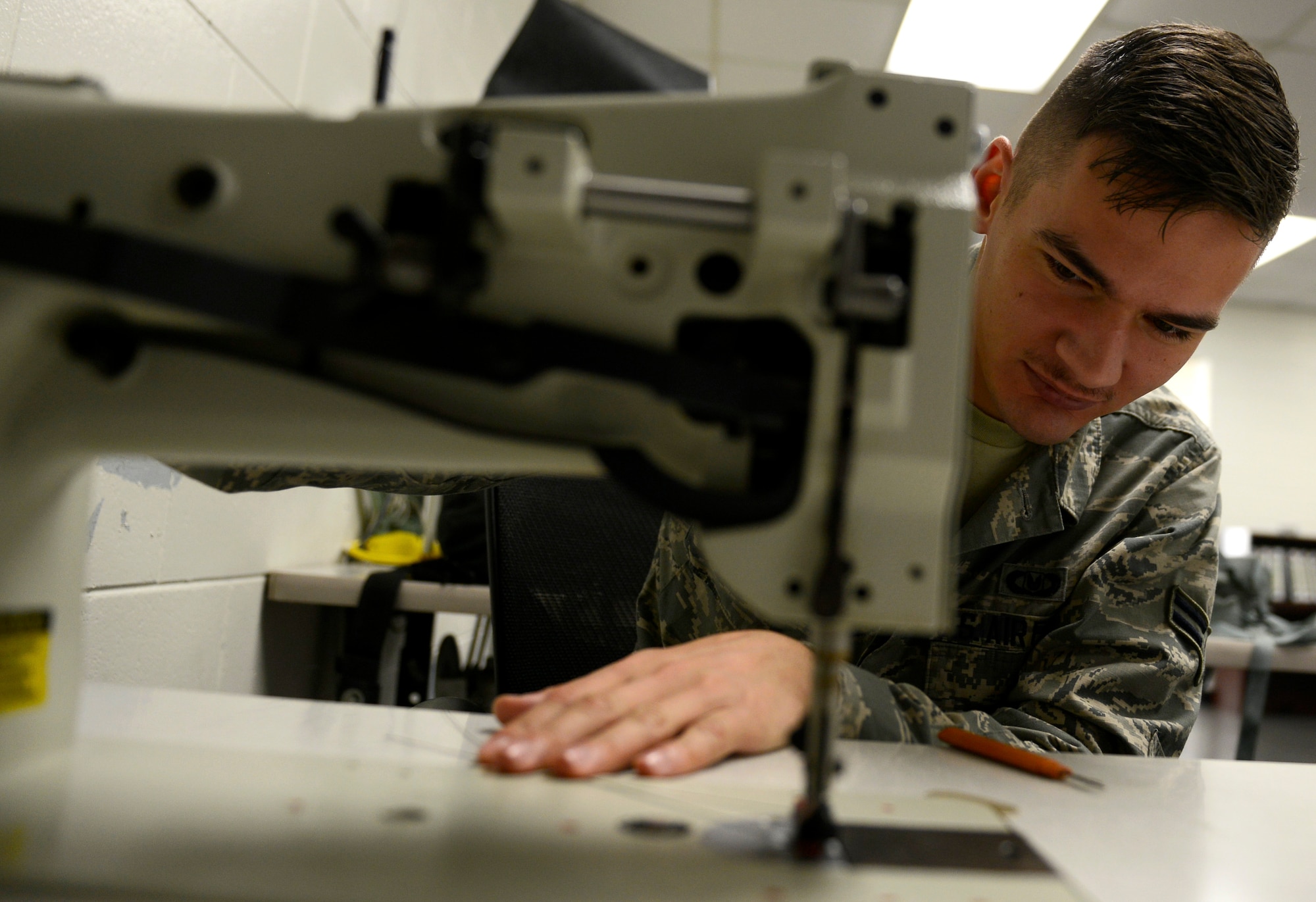 U.S. Air Force Airman 1st Class Kyle Denzine, 20th Operation Support Squadron aircrew flight equipment specialist, rigs a locking loop to hold down the pilot parachute to a mortar tube at Shaw Air Force Base, S.C., Oct. 6, 2015. These loops are replaced during every annual inspection to reduce the possibility of a premature deployment. The locking loop holds down the pilot parachute which is used to pull the C9 canopy from the ACES II container during egress. (U.S. Air Force photo by Airman 1st Class Christopher Maldonado/Released)
