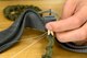 A U.S. Air Force Airman rigs the risers of the ACES II parachute system at Shaw Air Force Base, S.C., Oct. 8, 2015. The risers are the lowest part of the entire assembly and connect the parachute to the harness worn by the pilot during flight.  The elastic cord assembly keeps the risers secure during flight. (U.S. Air Force photo by Airman 1st Class Christopher Maldonado/Released) 