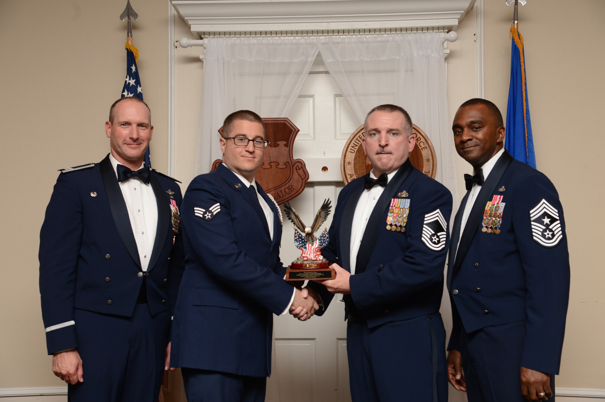 U.S. Air Force Senior Airman Michael DeMasi, 3rd Intelligence Squadron, receives the John L. Levitow Award for the Senior Master Sgt. David B. Reid Airman Leadership School Class 15-7, from Chief Master Sgt. James McMurdy, 20th Security Forces Squadron superintendent, at Shaw Air Force Base, S.C., Oct. 9, 2015. The Levitow Award is given to the graduate with the highest average of instructor and student points, and is the highest award in enlisted professional military education. (U.S. Air Force photo by Senior Airman Jonathan Bass/Released)