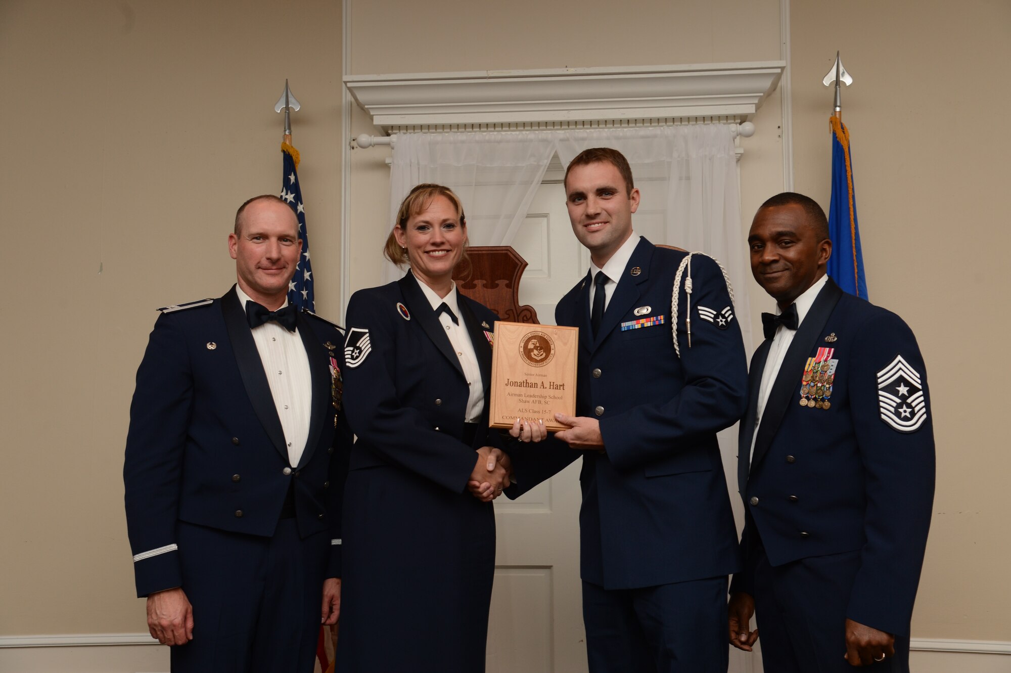 U.S. Air Force Senior Airman Jonathan Hart, 3rd Intelligence Squadron, receives the Senior Master Sgt. David B. Reid Airman Leadership School Commandant’s Award from Master Sgt. Lindsey Wolf, 20th Force Support Squadron ALS commandant, during the ALS Class 15-7 graduation at Shaw Air Force Base, S.C., Oct. 9, 2015. The Commandant’s award is given to the student who most exemplifies professional military qualities as chosen by their peers, the primary instructors, and the ALS commandant. (U.S. Air Force photo by Senior Airman Jonathan Bass/Released)