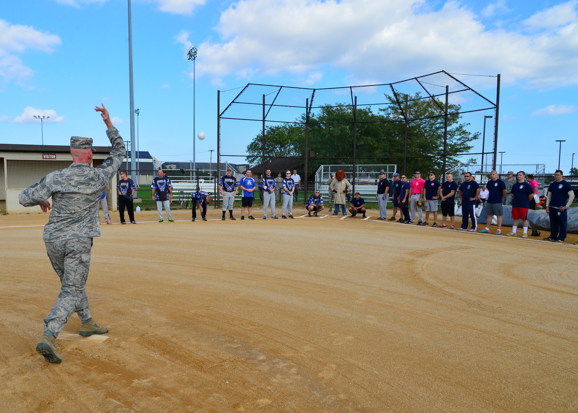 Chief Master Sgt. Christopher Pollock, 436th Mission Support Group superintendent, throws the ceremonial first pitch of the Battle of the Badges softball game Oct. 7, 2015, at the softball field on Dover Air Force Base, Del. This year marked the 25th anniversary of the Battle of the Badges. (U.S. Air Force photo/Senior Airman William Johnson)
