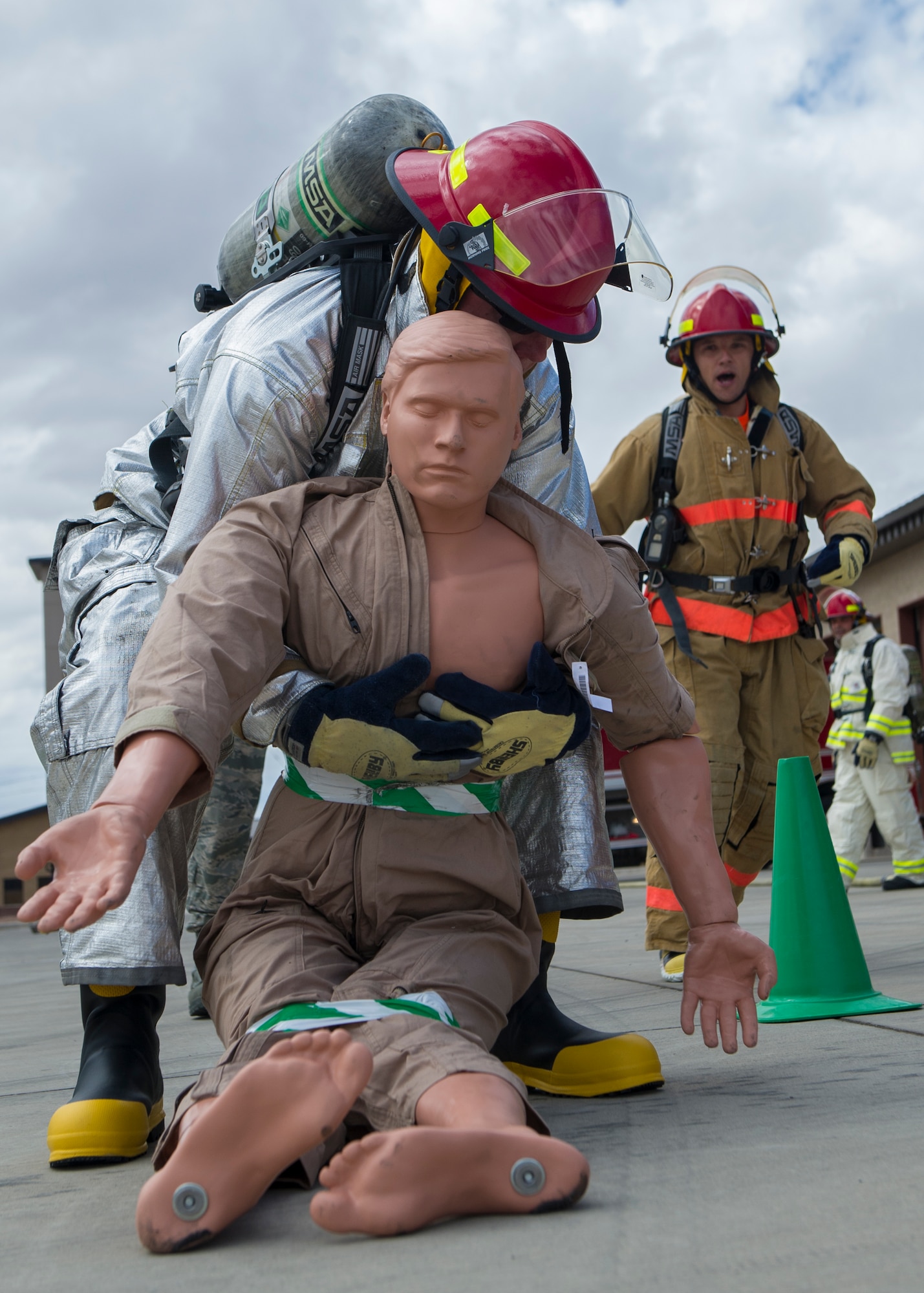 Captain Levi Beard, the 49th Civil Engineer Squadron operations flight commander, performs a buddy drag during the firefighter muster challenge at Holloman Air Force Base, N.M., Oct. 9, 2015. The firefighter muster challenge was one of the final events of Fire Prevention Week, which is recognized annually to commemorate those who lost their lives or property during the Great Chicago Fire of 1871. (U.S. Air Force photo by Airman 1st Class Emily A. Kenney/Released)