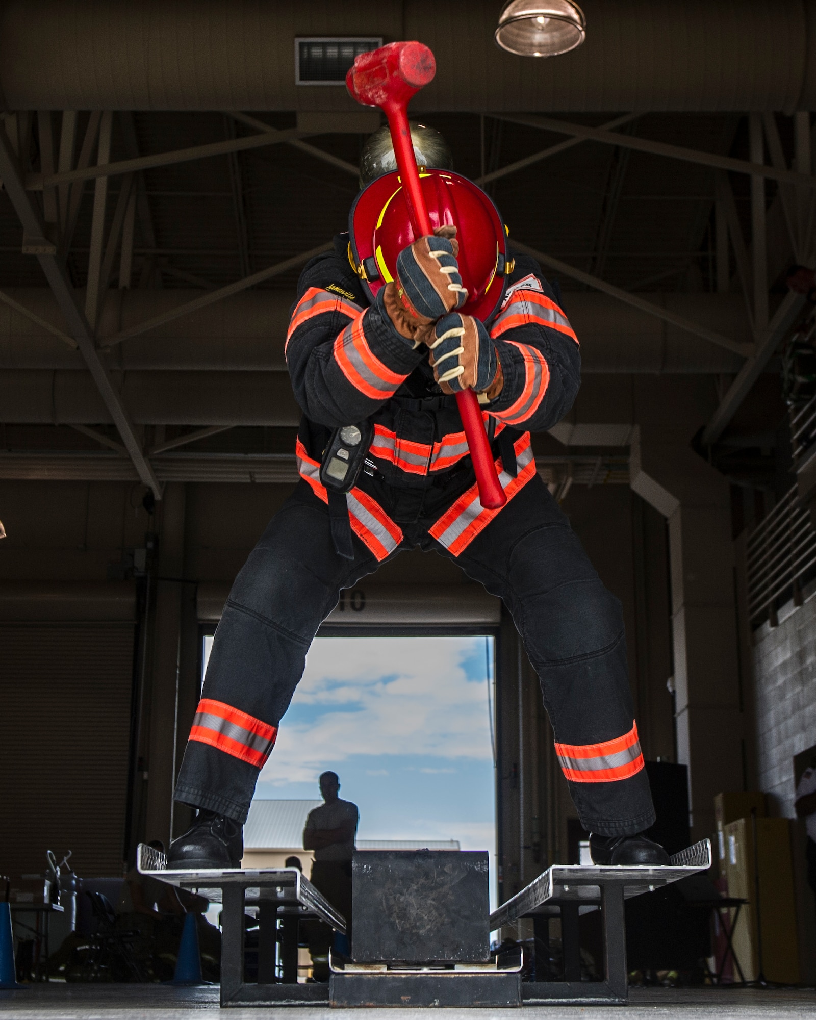 Rick Adler, the 49th Civil Engineer Squadron fire protection flight station captain, hits the Kiser sled during the firefighter muster challenge at Holloman Air Force Base, N.M., Oct. 9, 2015. The firefighter muster challenge was one of the final events of Fire Prevention Week, which is recognized annually to commemorate those who lost their lives or property during the Great Chicago Fire of 1871. (U.S. Air Force photo by Airman 1st Class Emily A. Kenney/Released)