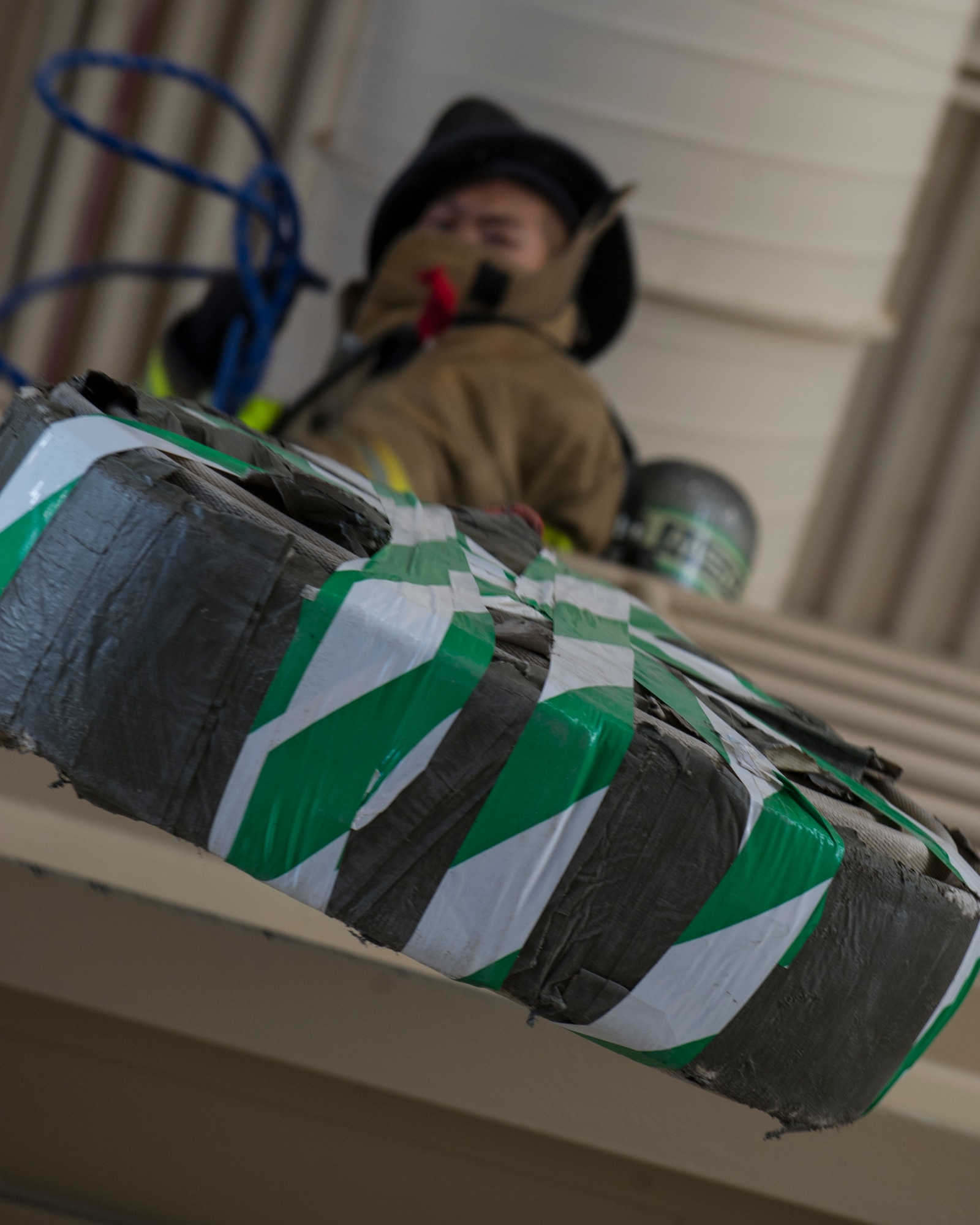Senior Airman Eugene Chang, from 49th Civil Engineer Squadron fire protections, pulls a high rise pack up a flight of stairs during the firefighter muster challenge at Holloman Air Force Base, N.M., Oct. 9, 2015. The firefighter muster challenge was one of the final events of Fire Prevention Week, which is recognized annually to commemorate those who lost their lives or property during the Great Chicago Fire of 1871. (U.S. Air Force photo by Airman 1st Class Emily A. Kenney/Released) 