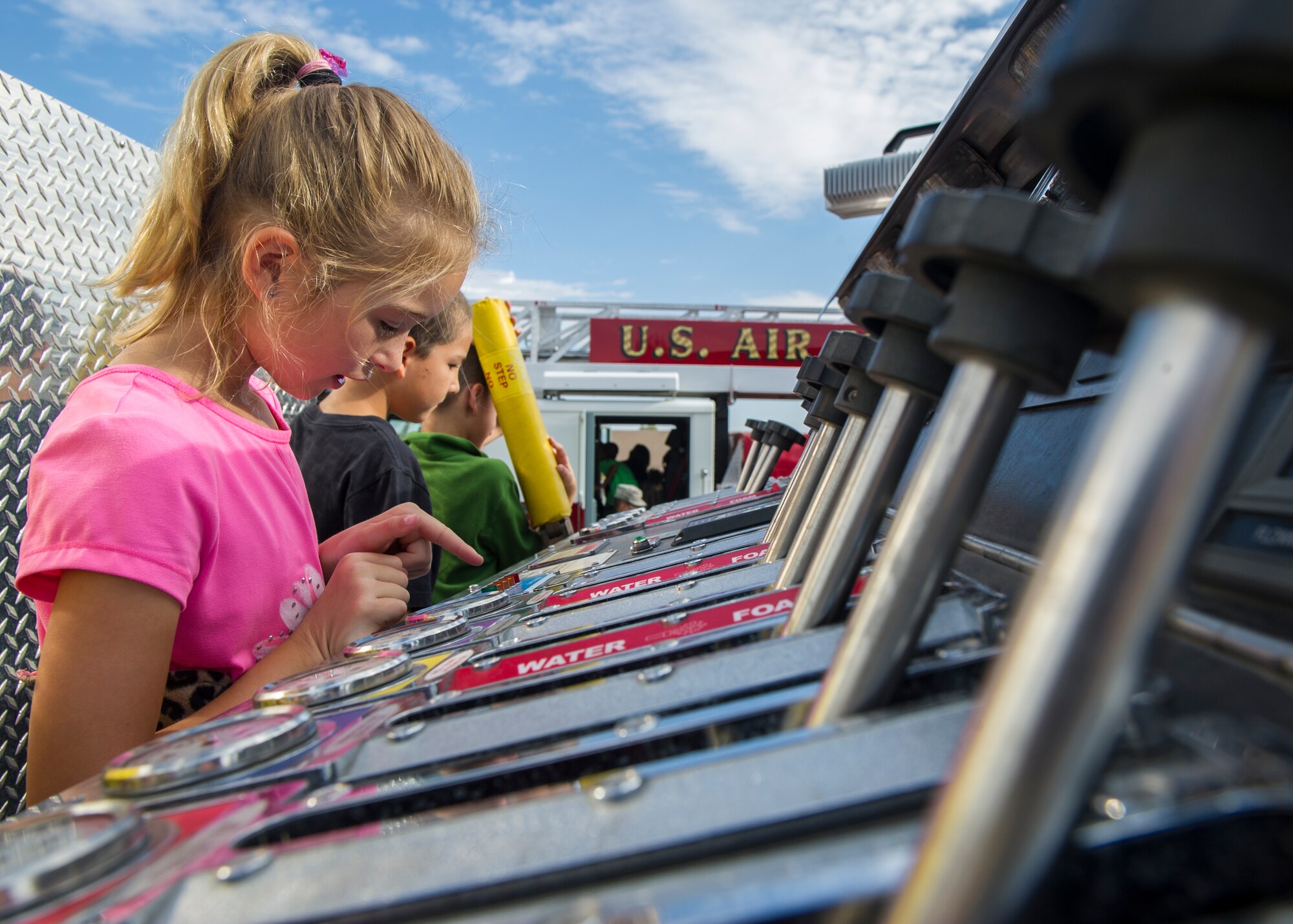 Children observe fire engine components during a visit at Holloman Elementary School, Oct. 6, 2015. Firefighters from around Holloman began the week by visiting Holloman’s elementary and middle schools with Sparky the Fire Dog. Children were able to explore the fire trucks and learn the importance of practicing fire safety every day. (U.S. Air Force photo by Airman 1st Class Emily A. Kenney/ Released)