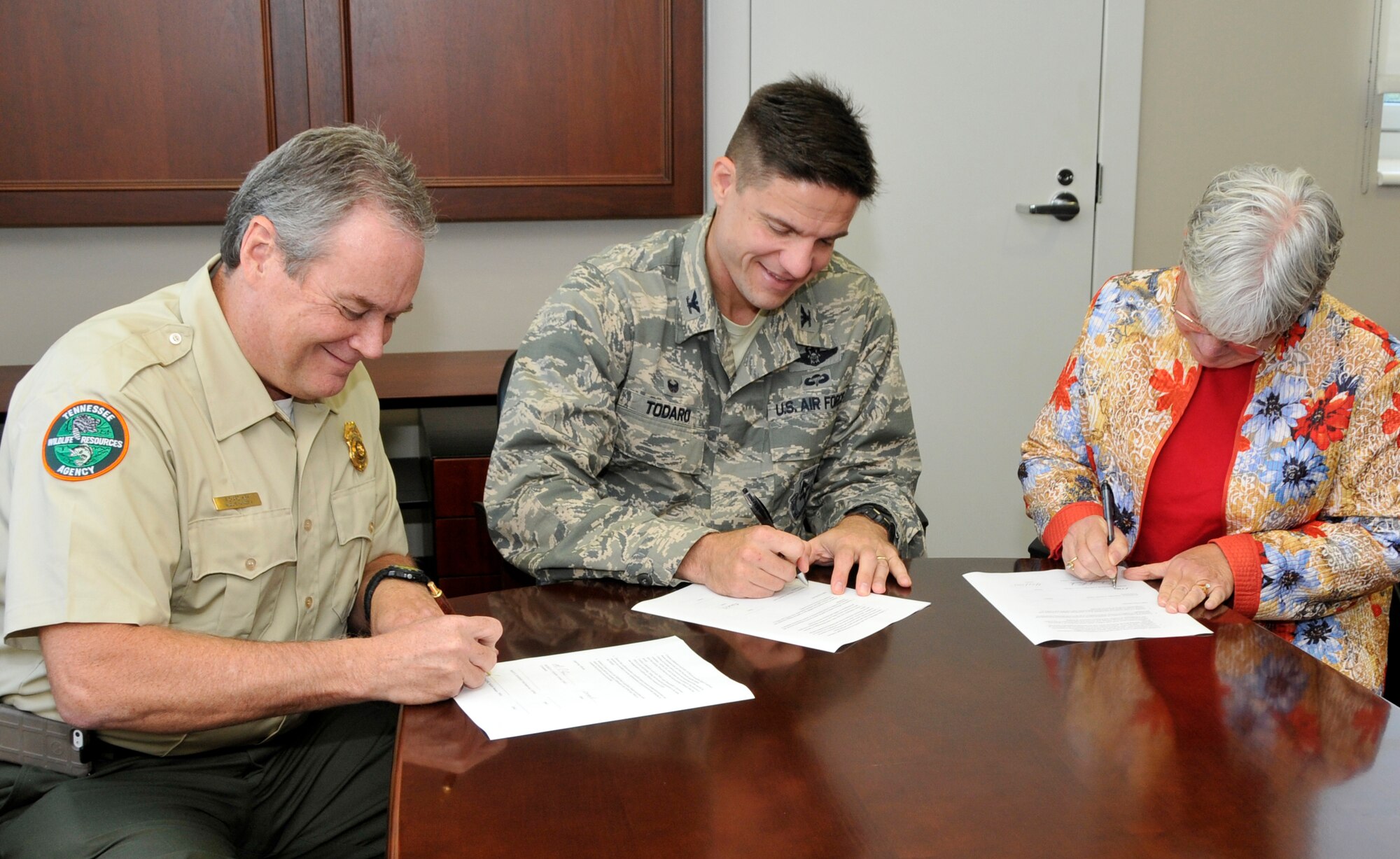 Col. Rodney Todaro (middle), commander of the Arnold Engineering Development Complex, signs the annual Integrated Natural Resources Management Plan alongside Richard Kirk (left), manager at the Region II Office of the Tennessee Wildlife Resources Agency, and Mary Jennings, supervisor at the Tennessee Ecological Services Field Office of the United States Fish and Wildlife Service on Aug. 26 at AEDC. Arnold Air Force Base has significant natural resources requiring conservation and management, including habitat for federally listed species protected under the Endangered Species Act and the presence of unique biological resources such as wetlands like Sinking Pond, a property designated a National Natural Landmark by the United States Department of the Interior.  Arnold collaboratively manages the installation’s natural resources with assistance from the USFWS and TWRA to protect and conserve natural resources while providing hunting, fishing and outdoor recreation opportunities to the public. (Photo by Jacqueline Cowan)

-AEDC-
