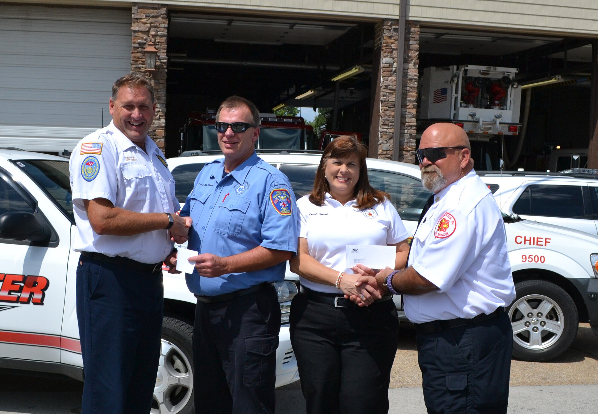 ATA, the operating contractor for Arnold Engineering Development Complex, recently presented separate $100 charitable donations to the Tullahoma and Manchester Fire Departments to support their Elementary School Fire Prevention Program. Pictured from left are Tullahoma Fire Department Capt. Jeff Smith, ATA Paramedic/Firefighter Scott McPherson, ATA Administrative Assistant Carol Smith and Manchester Fire Department Chief George Chambers. (Photo provided)