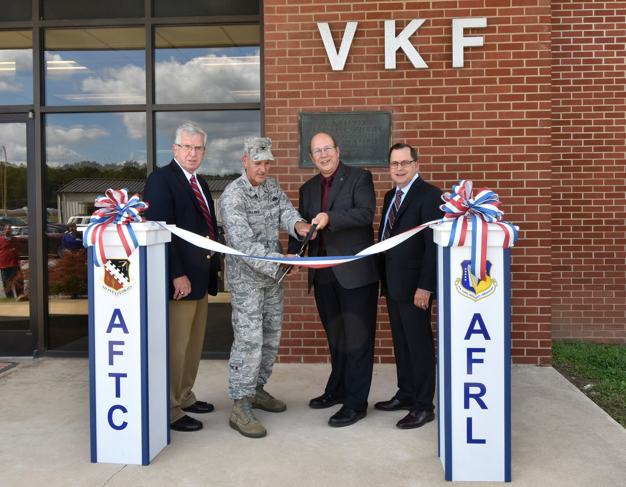 A ribbon cutting ceremony was held at the von Kármán Gas Dynamics Facility to recognize the renovations taking place at the facility to accommodate the new High Speed Experimentation Branch at AEDC. The branch, headed by Air Force Research Laboratory staff with Glenn Liston as branch chief, can now conduct foundational and systems research in propulsion, aeronautics and structural applications providing technology maturation related to hypersonic flight. The VKF building renovations will also be beneficial to AEDC team members who support the three VKF wind tunnels, as well as those who support APTU. Pictured taking part in the ribbon cutting ceremony are Dr. Edward Kraft, AEDC chief technologist; Col. James Krajewski, chief of AEDC Test Support Division; Glenn Liston, chief of AEDC High Speed Experimentation Branch; and Dr. Mark Mehalic, AEDC executive director. (Photo by Jacqueline Cowan)