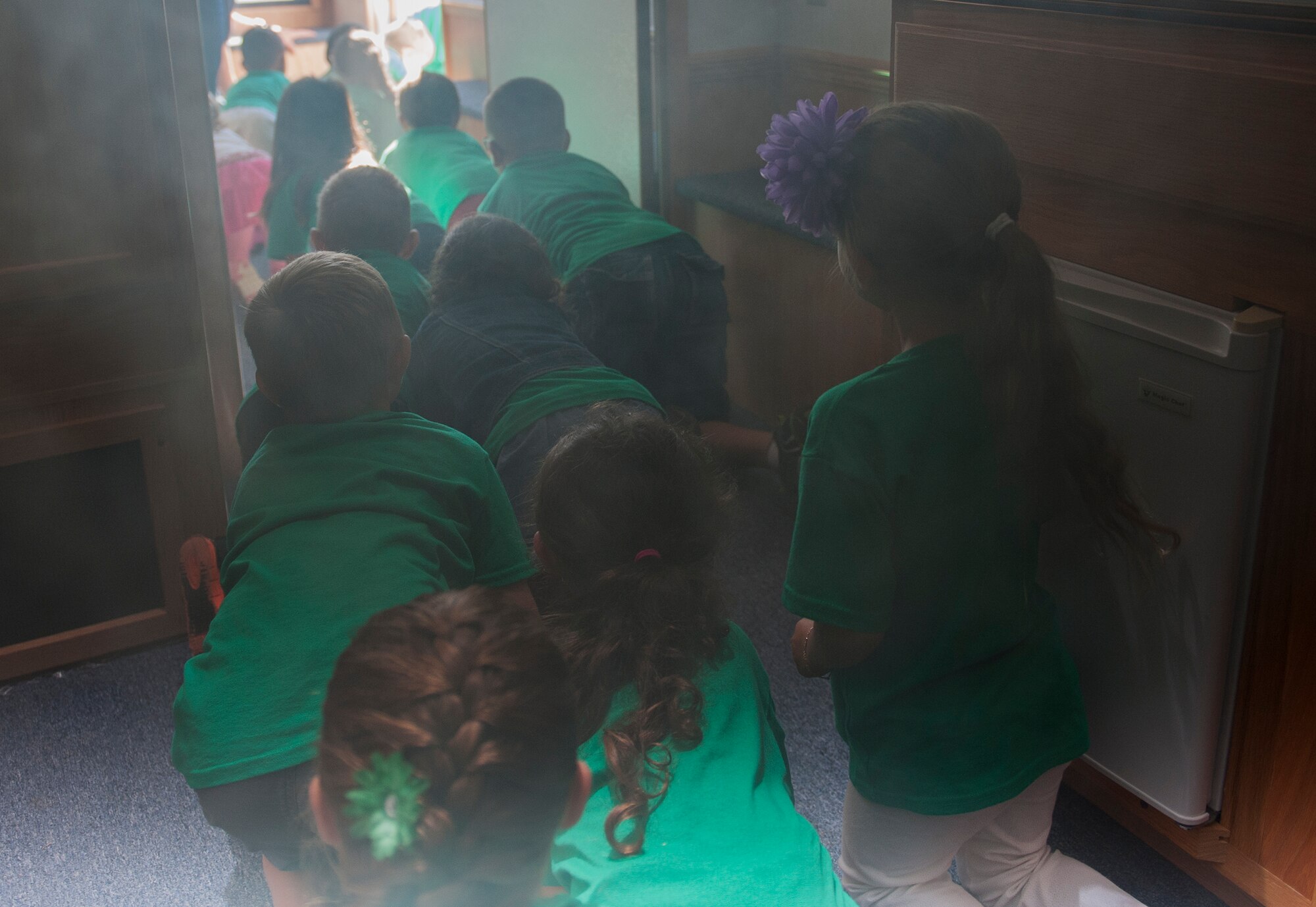 Children from the Eglin Elementary School exit the 96th Civil Engineer Squadron’s Fire Safety House Oct. 6 during Fire Prevention Week at Eglin Air Force Base, Fla. Eglin Fire Department personnel provided basic fire safety education that included the importance of knowing your address, how to dial 911 during an emergency as well as cooking and electrical safety. The children also practiced how to stay low and escape a smoke filled house. (U.S. Air Force photo/Ilka Cole) 