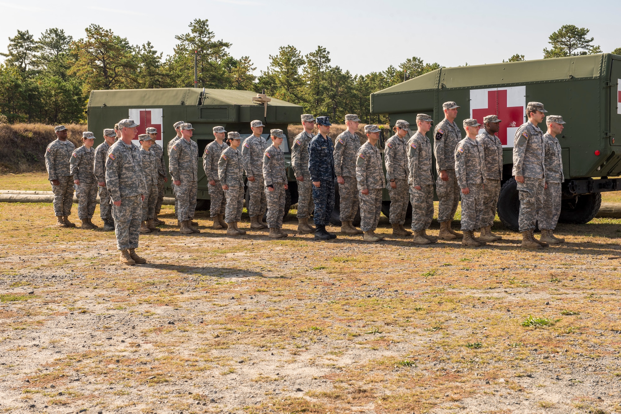 A group of 23 candidates line review their gear after a 12-mile road march during an Expert Field Medical Badge competition at Joint Base McGuire-Dix-Lakehurst, N.J., Oct. 6, 2015. The road march was limited to three hours, while carrying nearly 40 pounds of equipment. Twenty one of the 23 finished the ruck to earn the coveted medical badge, including a Sailor and an Airman. (U.S. Air Force photo by Senior Airman Tara A. Williamson/Released)