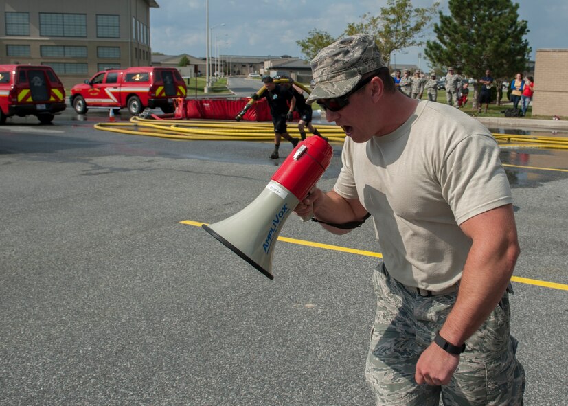 Tech. Sgt. Zachary Sielaff, 436th Civil Engineer Squadron lead fire inspector, shouts instructions through a megaphone during the 2015 Fire Muster Oct. 8, 2015, at Dover Air Force Base, Del. The fire muster was organized in conjunction with Fire Prevention Week. (U.S. Air Force photo/Senior Airman Zachary Cacicia)
