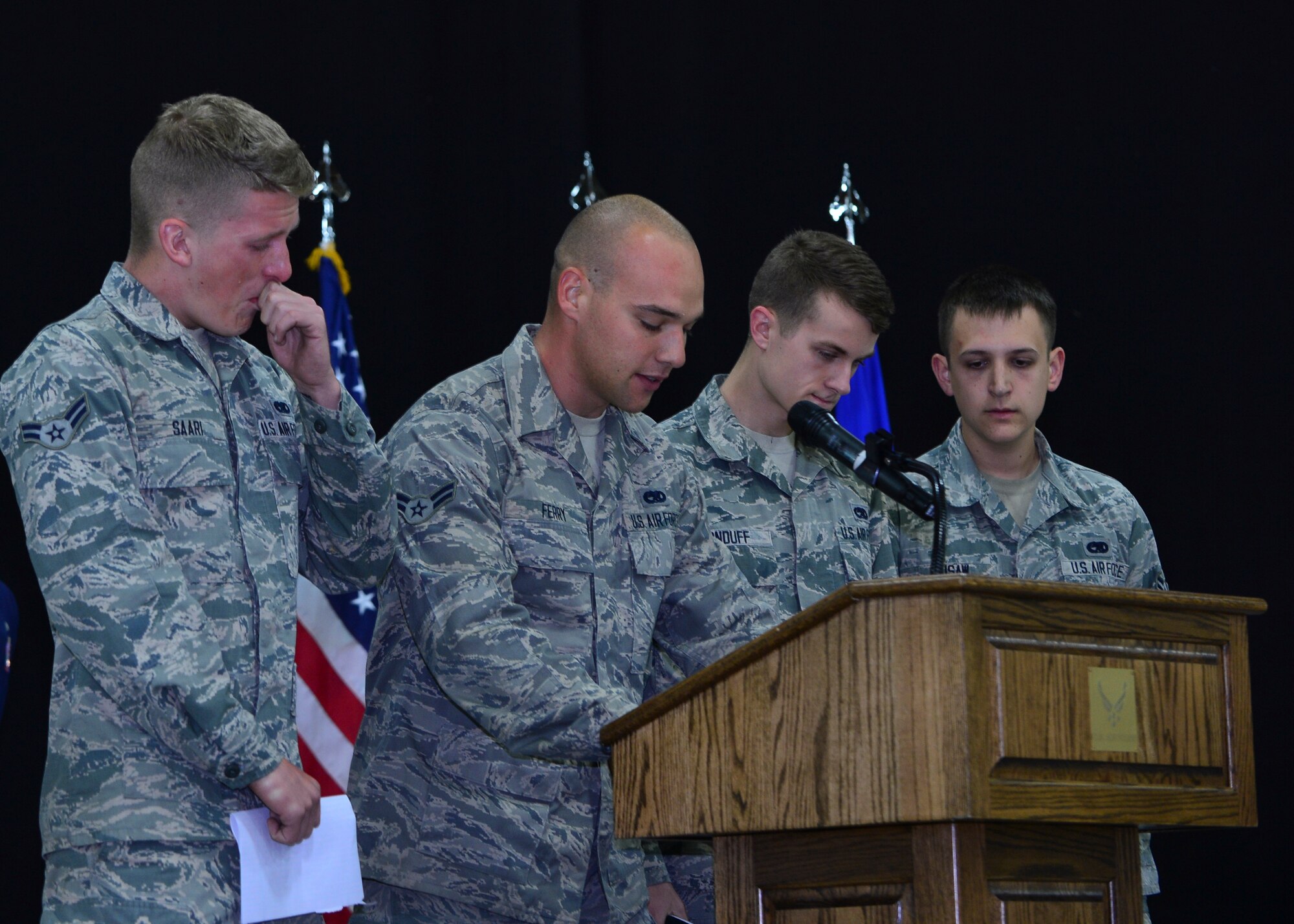 Four friends of Airman 1st Class Darren Phillips, 48th EMS crew chief, pay tribute to Phillips during a memorial ceremony held at Royal Air Force Lakenheath, England, Oct. 11, 2015. Phillips died from injuries sustained in a motorcycle accident on Oct. 2. (U.S. Air Force photo by Staff Sgt. Stephanie Longoria/Released)
