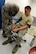 Airman 1st Class Troy Caillier (left), 4th Civil Engineer Squadron firefighter, practices taking blood pressure on Airman Tom Krasinski’s, 4th CES firefighter, Sept. 25, 2015, at Seymour Johnson Air Force Base, North Carolina. As first responders, firefighters are trained to react to medical emergencies as it’s possible they will have first contact with a victim. (U.S. Air Force photo/ Airman 1st Class Ashley Williamson)