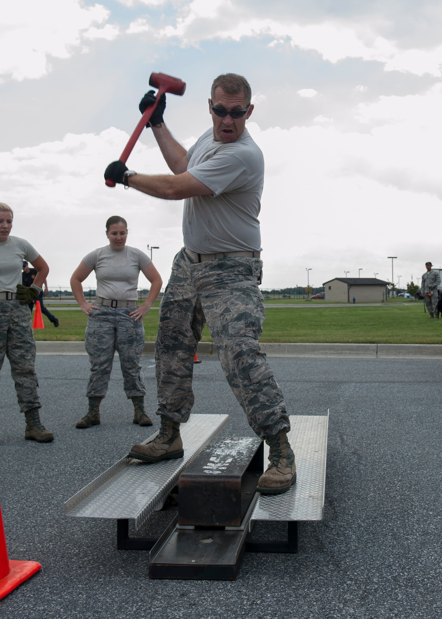 Lt. Col. Kevin Golart, 436th Civil Engineer Squadron commander, swings a sledge hammer at a Keiser sled during the 2015 Fire Muster Oct. 8, 2015, at Dover Air Force Base, Del. The force needed to move the sled simulates the force needed for firefighters to gain forcible entry into a structure. (U.S. Air Force photo/Senior Airman Zachary Cacicia)