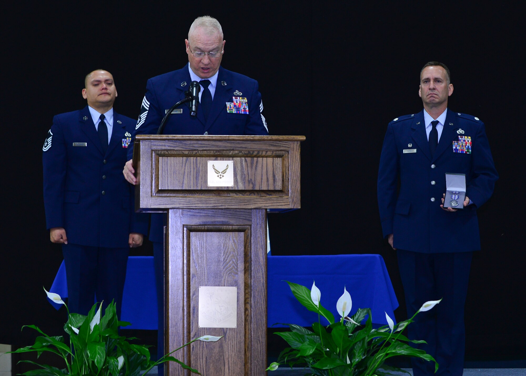 Chief Master Sgt. Timothy Jordan, 48th Equipment Maintenance Squadron superintendent, reads an Air Force Achievement medal citation at a memorial ceremony for Airman 1st Class Darren Phillips, 48th EMS crew chief, for his service and accomplishments while stationed at Royal Air Force Lakenheath, England, Oct. 11, 2015. Phillips died from injuries sustained in a motorcycle accident on Oct. 2. (U.S. Air Force photo by Staff Sgt. Stephanie Longoria/Released)