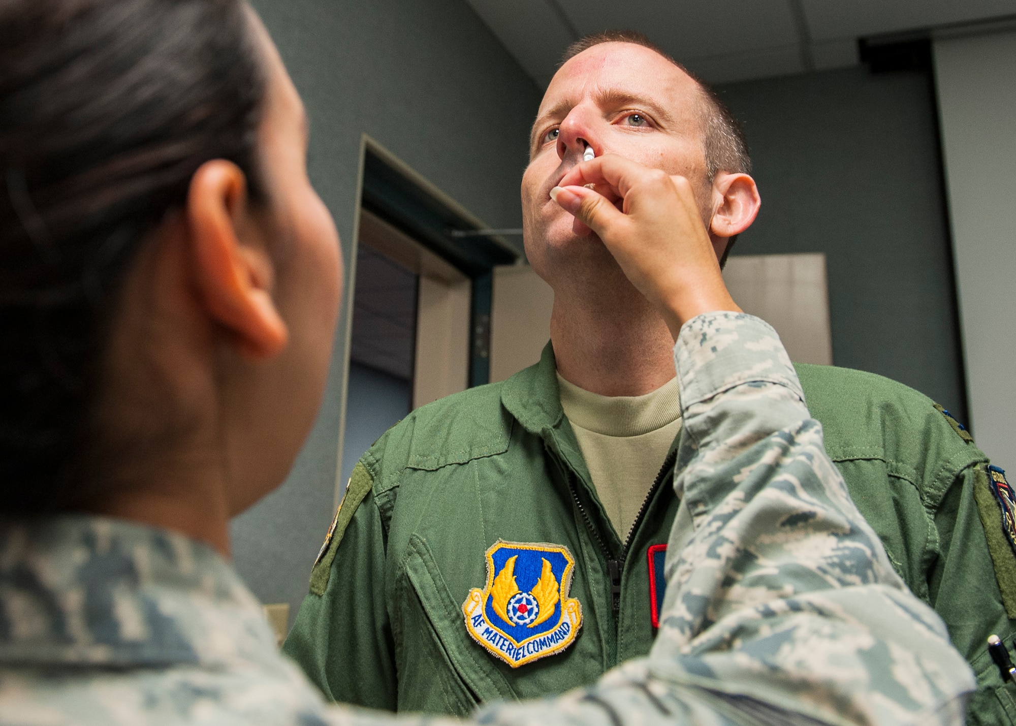 Col. Matthew Higer, 96th Test Wing vice commander, receives a nasal spray flu vaccination Oct. 8 at Eglin Air Force Base, Fla. A mass influenza vaccine line for active duty only is Oct. 26-29 at building 439 from 7 a.m. to 5 p.m. and on Oct. 30 from 7 a.m. to 1 p.m. on a first-come, first-serve basis. The auditorium is located on West F Avenue, across from the library on the East side of the base. Immunization is key to flu prevention and recommended for everyone six-months of age and older.  (U.S. Air Force photo/Ilka Cole)