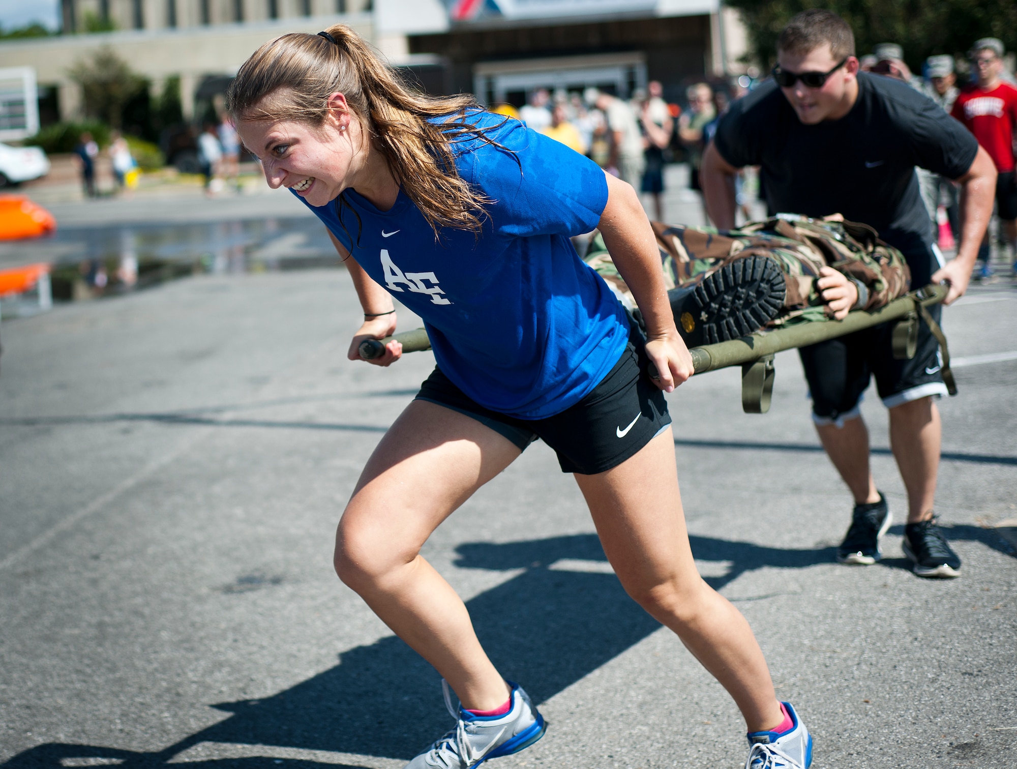 A participant runs while carrying a simulated victim on a stretcher during the Fire Muster Challenge Oct. 9 at Eglin Air Force Base, Fla.  Teams competed in the timed challenge that included shooting and rolling up the fire hose, hammer sled, victim-carry and water relay. The challenge closed out the base’s Fire Prevention Week activities.  (U.S. Air Force photo/Samuel King Jr.)
