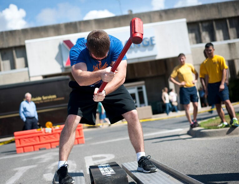 A participant hammers down on a sled during the Fire Muster Challenge Oct. 9 at Eglin Air Force Base, Fla.  Teams competed in the timed challenge that included shooting and rolling up the fire hose, hammer sled, victim-carry and water relay. The challenge closed out the base’s Fire Prevention Week activities.  (U.S. Air Force photo/Samuel King Jr.)