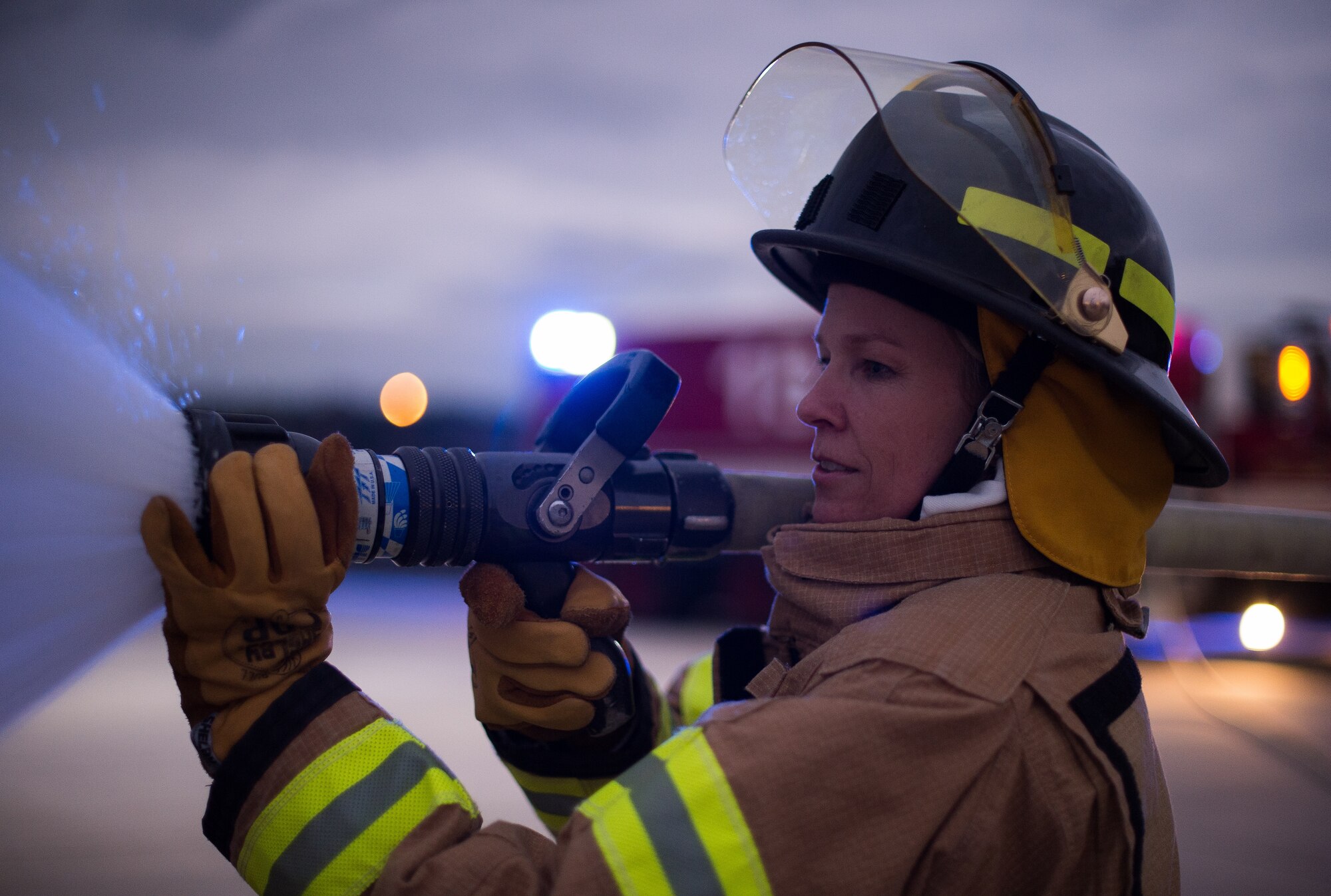 Col. Laura Johnson, 86th Civil Engineer Group commander practices using a fire hose Oct. 8, 2015, at Ramstein Air Base, Germany. Leadership from throughout Ramstein helped 86th Civil Engineer Squadron firefighters demonstrate to attendees how they extinguish an aircraft fire as part of Fire Prevention Week. (U.S. Air Force photo/Senior Airman Damon Kasberg)