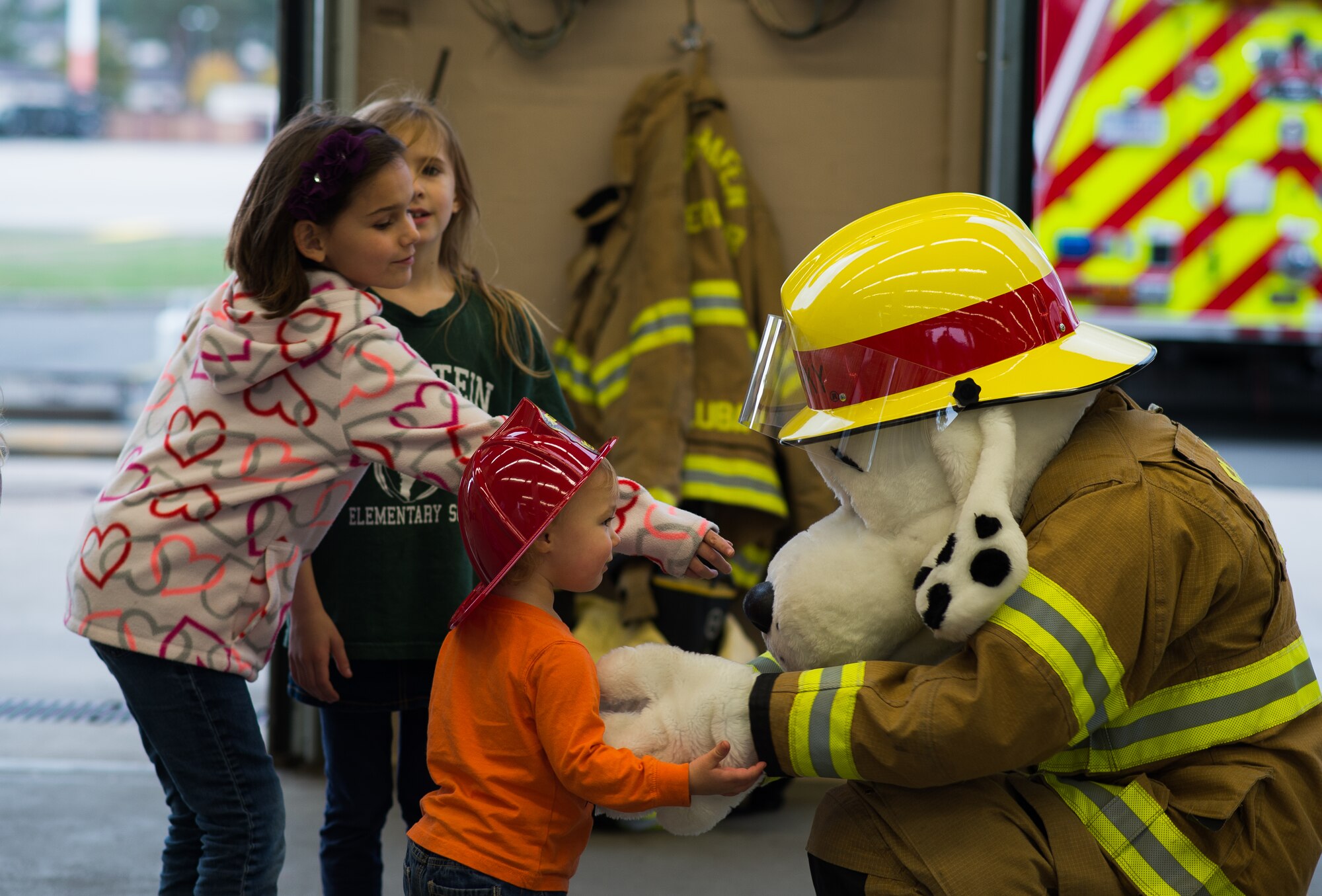 Sparky the Fire Dog interacts with children attending an open house Oct. 8, 2015, at Ramstein Air Base, Germany. The event was hosted by the 86th Civil Engineer Squadron to promote Fire Prevention Week. (U.S. Air Force photo/Senior Airman Damon Kasberg)