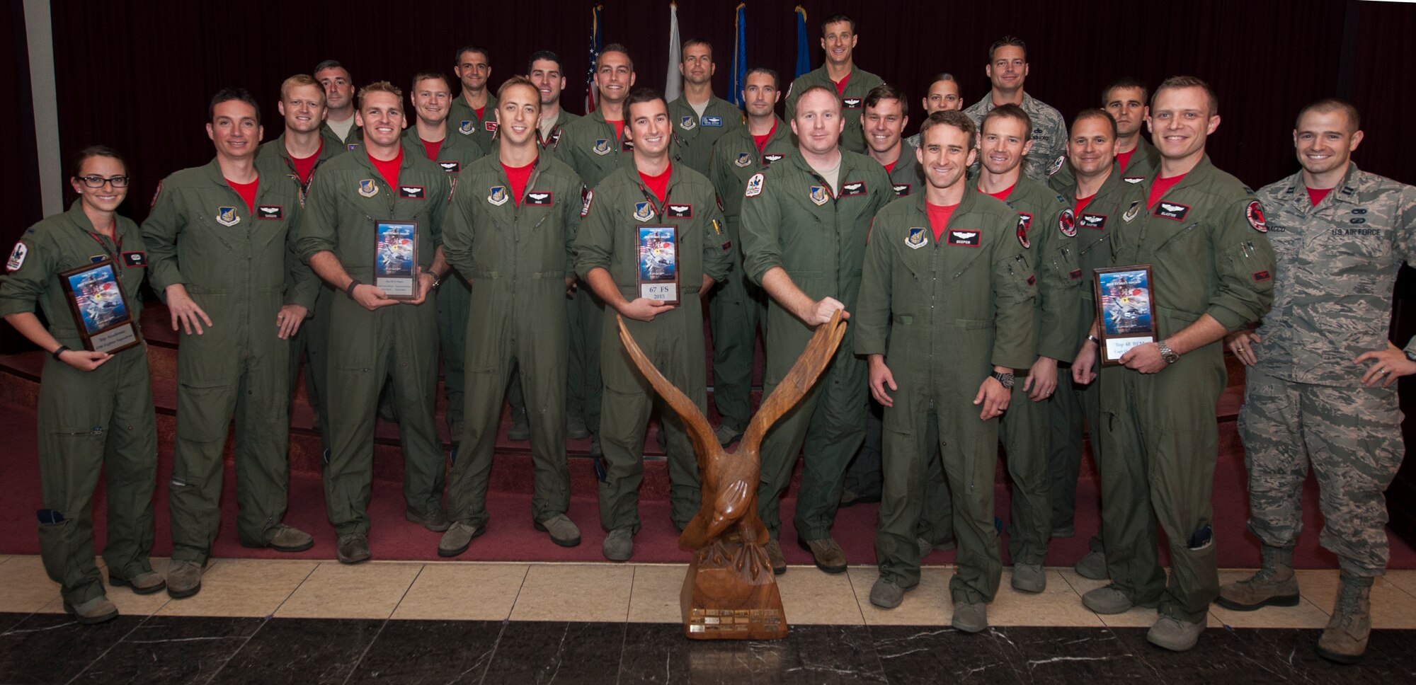 U.S. Air Force Airmen from the 67th Fighter Squadron receive the Top Fighter Squadron Award at the 2015 Turkey Shoot awards ceremony Oct. 9, 2015, on Kadena Air Base Japan. The award was presented to the 67th FS as a result of a series of scenarios including academic knowledge tests and tactical attack and defense simulations. (U.S. Air Force photo by Airman 1st Class Corey M. Pettis) 