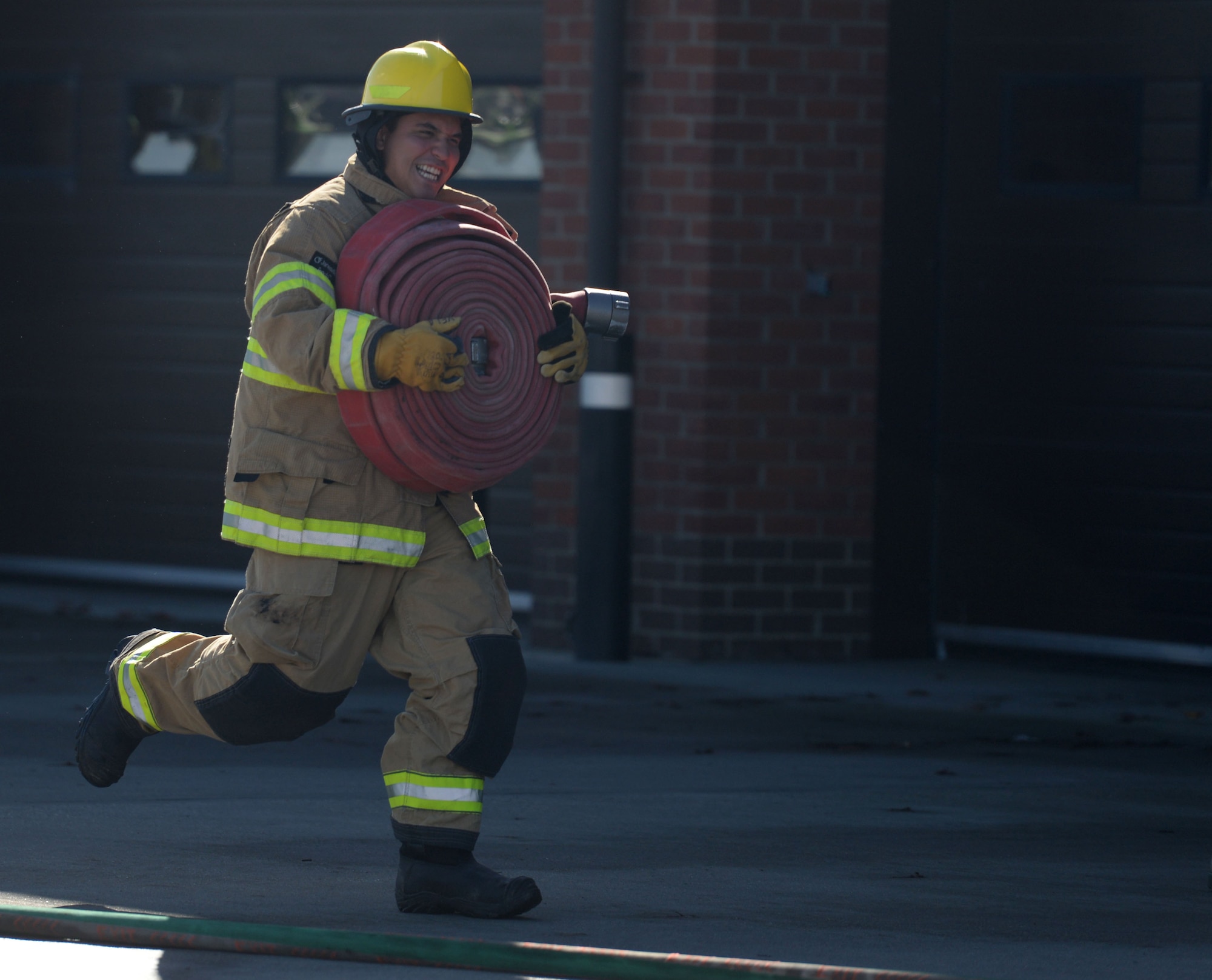 U.S. Air Force Senior Airman Justin Peredo, 100th Civil Engineer Squadron Heating, Ventilation and Air Conditioning journeyman, takes part in the fire muster competition Oct. 8, 2015, on RAF Mildenhall, England. The fire muster enabled families to come together to raise awareness of fire prevention through healthy competition and family friendly activities. (U.S. Air Force photo by Gina Randall/Released)