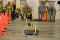 Team Mildenhall Airmen and civilians take part in the fire muster competition Oct. 8, 2015, on RAF Mildenhall, England. Teams were made up of four members taking part in team events to raise awareness of fire prevention. (U.S. Air Force photo by Gina Randall/Released)