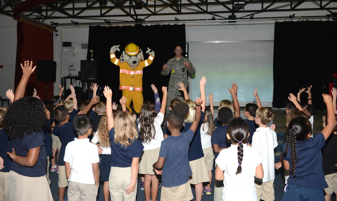 Sparky the Fire Dog visits Andersen Elementary School students Oct. 6, 2015, at Andersen Air Force Base, Guam. The firefighters demonstrated the importance of fire safety to the students in observance of Fire Prevention Week. (U.S. Air Force photo by Airman 1st Class Arielle Vasquez/Released)